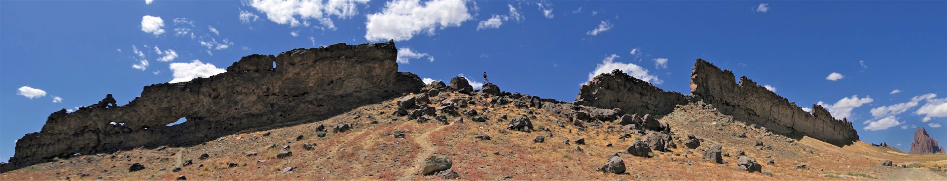 Photographer Sean Nicholas McMullen standing high among the wings of Shiprock